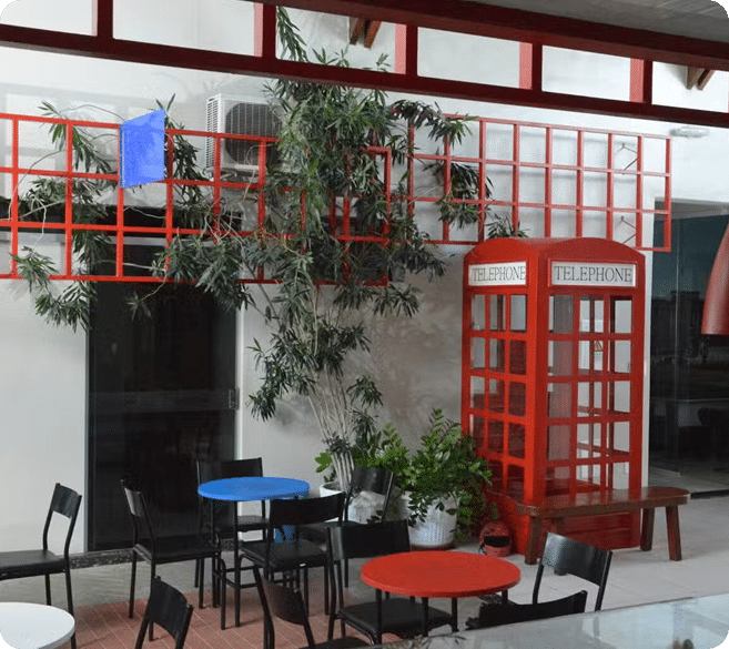 Red telephone booth in cafe setting